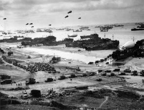 Landing ships putting cargo ashore on Omaha Beach, at low tide during the first days of the operation, mid-June, 1944. Author: US Government.