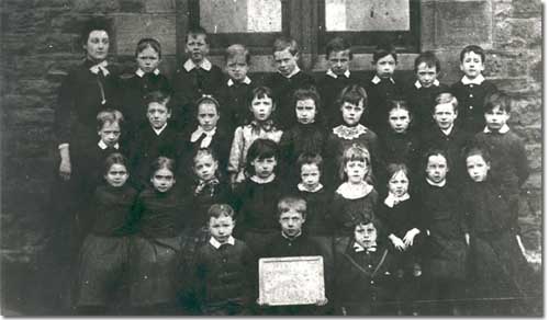 A typical 19th century school photograph showing a primary class.