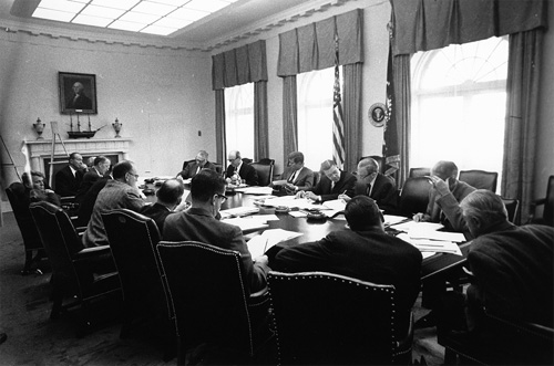 President Kennedy in a crowded Cabinet Room during the Cuban Missile Crisis.
