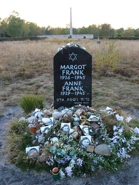 Memorial for Margot and Anne Frank at the former Bergen-Belsen site, along with floral and pictorial tributes.