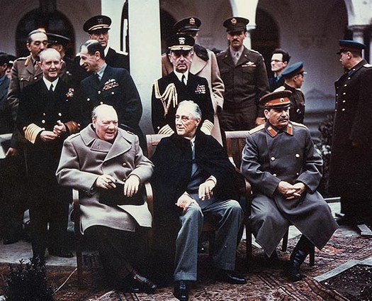 The 'Big Three' at the Yalta Conference, Winston Churchill, Franklin D. Roosevelt and Joseph Stalin. Also present are Admiral of the Fleet Sir Andrew Cunningham, RN, Marshal of the RAF Sir Charles Portal, RAF (both standing behind Churchill); and Fleet Admiral William D. Leahy, USN, (standing behind Roosevelt).