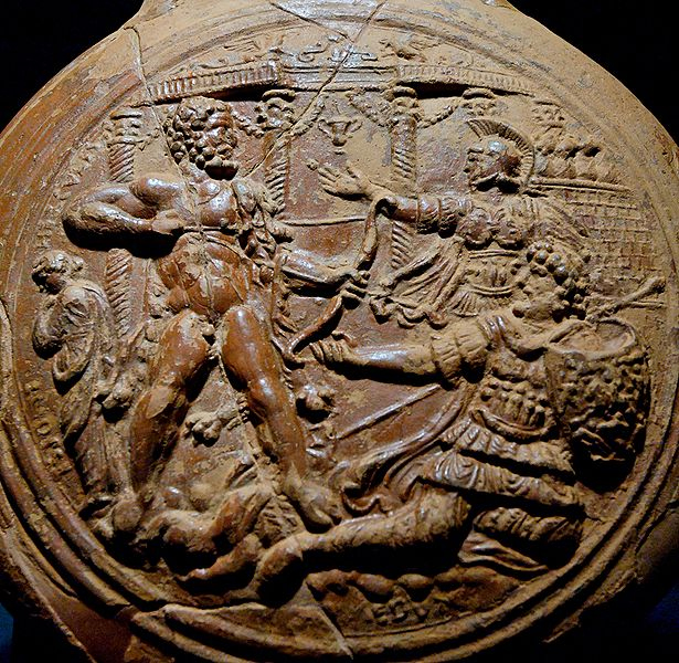 Herakles (on the left) about to kill Laomedon, king of Troy (on the right). Behind Herakles stands Hesione, raising her right hand to her chin in sign of melancholy. Side A from a terra sigillata flask by the workkshop of Felix (Southern Gaul), late 1st–early 2nd century CE. From the necropolis of Lugone in Salò. Stored in the Museo Civico Archeologico della Valle Sabbia in Gavardo (Brescia).
