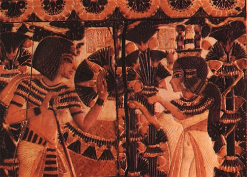 Tutankhamun receives flowers from Ankhesenamun. This image is on the lid of a box found in Tut's tomb.