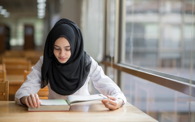 Muslim girl student studying at the library. Image ID:510551062. Copyright: Kdonmuang