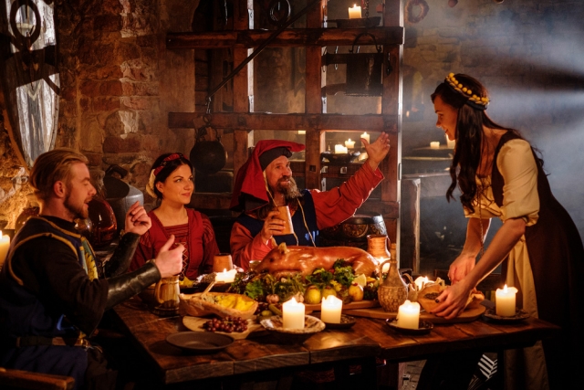 Medieval people eat and drink in ancient castle kitchen interior. Shutterstock photo ID: 503301478