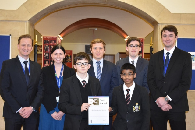 Staff and pupils of Merchant Taylor's with their QM award.