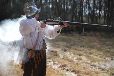 A modern re-enactor fires an arquebus