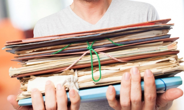 Teacher holding a pile of documents