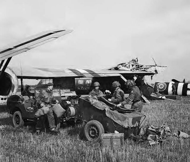 HQ of 1st Airlanding Light Regiment, Royal Artillery, unload a jeep and trailer from their Horsa glider at the landing zone near Wolfheze in Holland, 17 September 1944. © IWM (BU 1164)