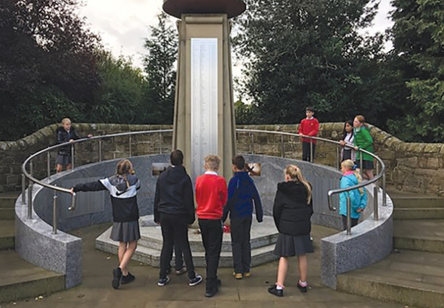 Schoolchildren at local war memorial