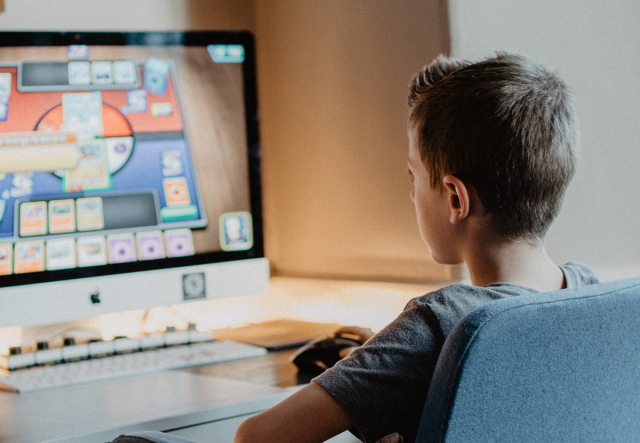 Boy working at computer (Photo by Kelly Sikkema on Unsplash)