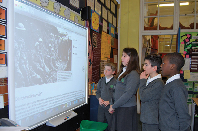 Primary children looking at materials by the HA