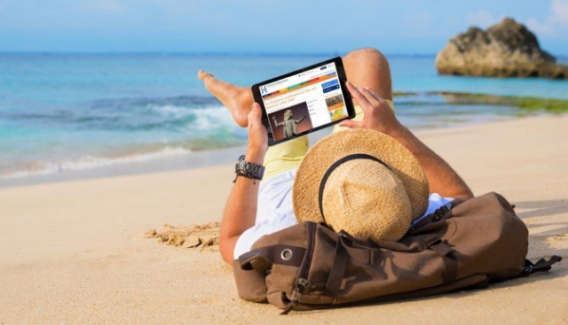 Man listening to podcast on beach