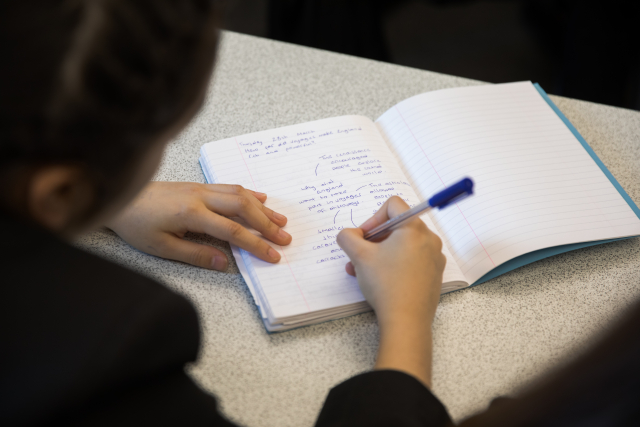A history student writing in class