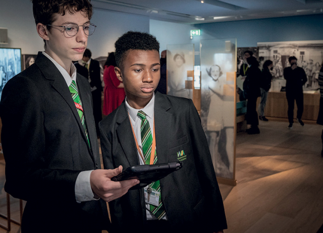 Students using learning devices during their self-led visit to the Holocaust Galleries